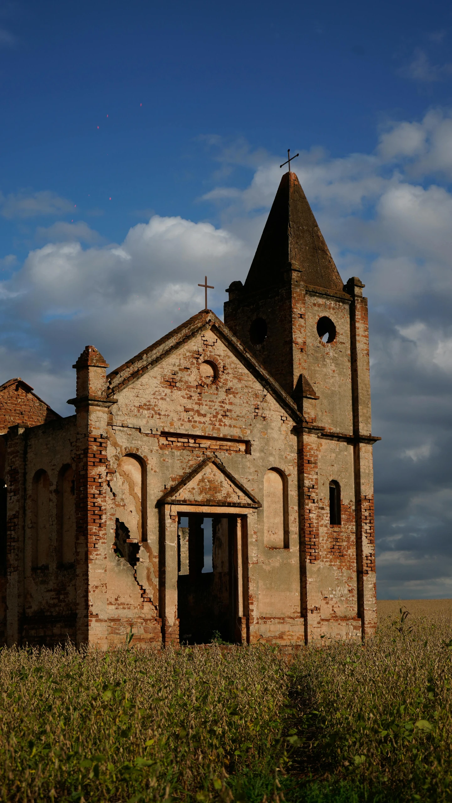 an old church in the middle of a field, an album cover, flickr, romanesque, rusted walls, shipibo, 2006 photograph, exterior view