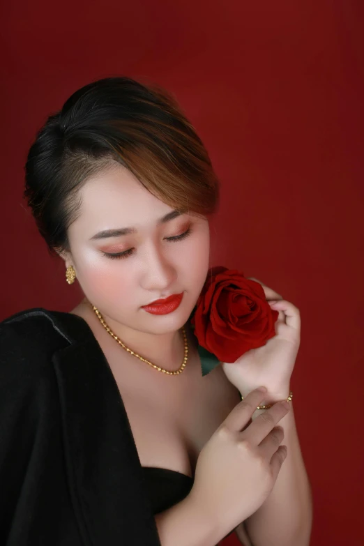 a woman in a black dress holding a red rose, an album cover, inspired by Ruth Jên, headshot profile picture, square, vietnamese woman, gold