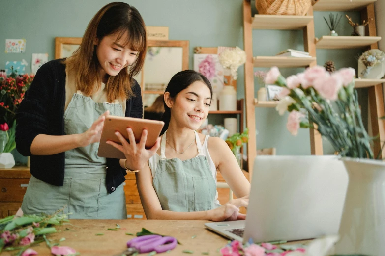 two women working on a laptop in a flower shop, a picture, trending on pexels, avatar image, asian woman, thumbnail, holding a clipboard