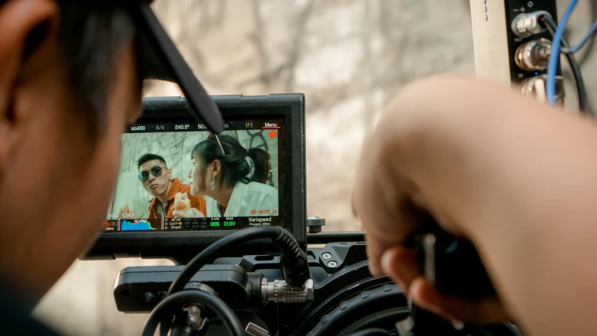 a close up of a person holding a camera, trending on pexels, video art, action movie scene, person in foreground, movie set”, picture through the screen