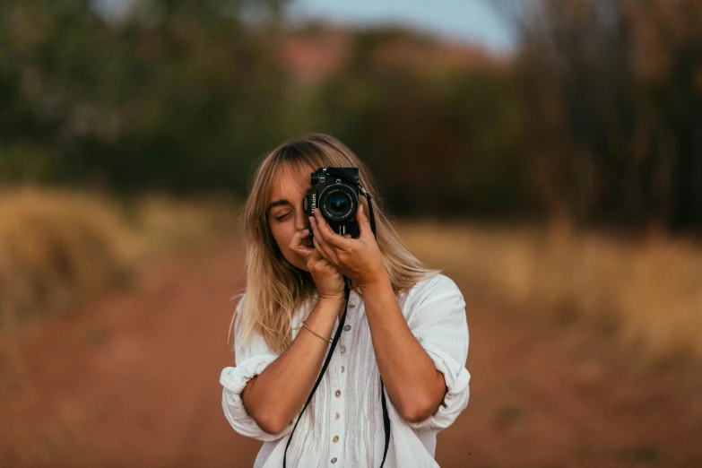 a woman taking a picture with a camera, a picture, by Lee Loughridge, unsplash contest winner, 🤠 using a 🖥, photoshoot for skincare brand, photo of the girl, focused shot