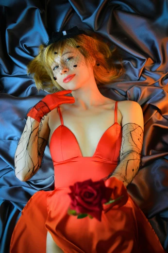 a woman in a red dress laying on a bed, an album cover, inspired by Karl Bryullov, flickr, portrait of asuka langley soryu, y 2 k cutecore clowncore, holding a rose, closeup - view