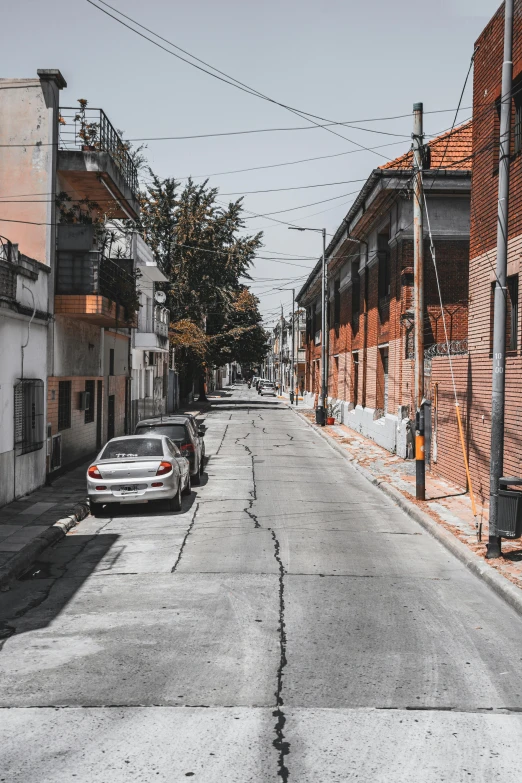 a black and white photo of an empty street, pexels contest winner, quito school, gray and orange colours, on a bright day, suburbia street, background image