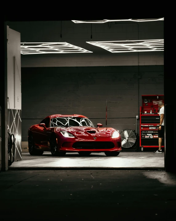 a red sports car parked in a garage, inspired by Elsa Bleda, pexels contest winner, on a racetrack, red lightning, red robes, gif