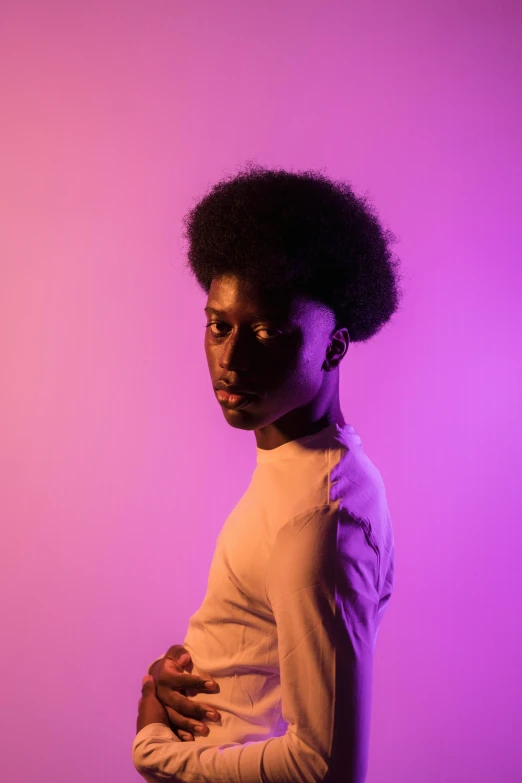 a woman standing in front of a purple background, by Winona Nelson, pexels contest winner, afrofuturism, black teenage boy, beautiful soft light, high key lighting, ( ( brown skin ) )