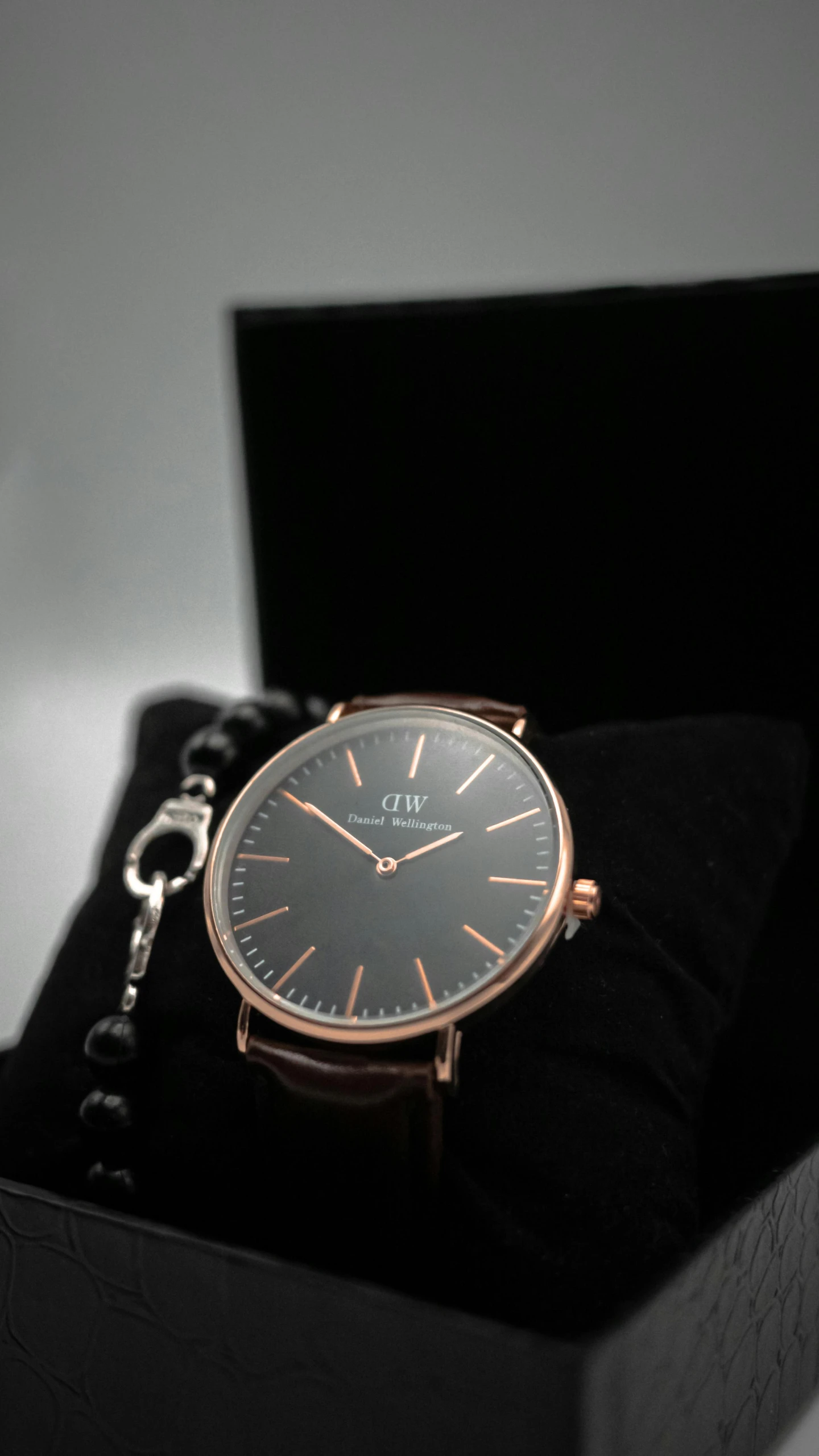 a close up of a watch in a box, unsplash, black and auburn colour pallet, thumbnail, rose gold, dark. no text