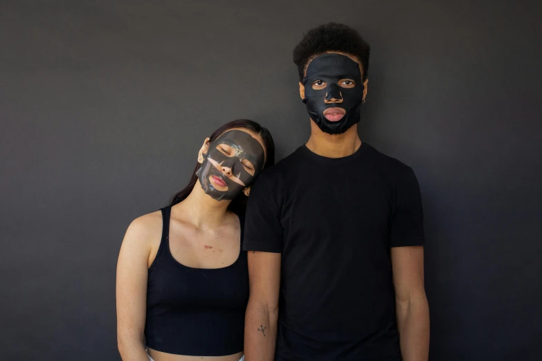 a man and a woman standing next to each other, pexels contest winner, antipodeans, black facemask, clean face and body skin, black paper, varying ethnicities