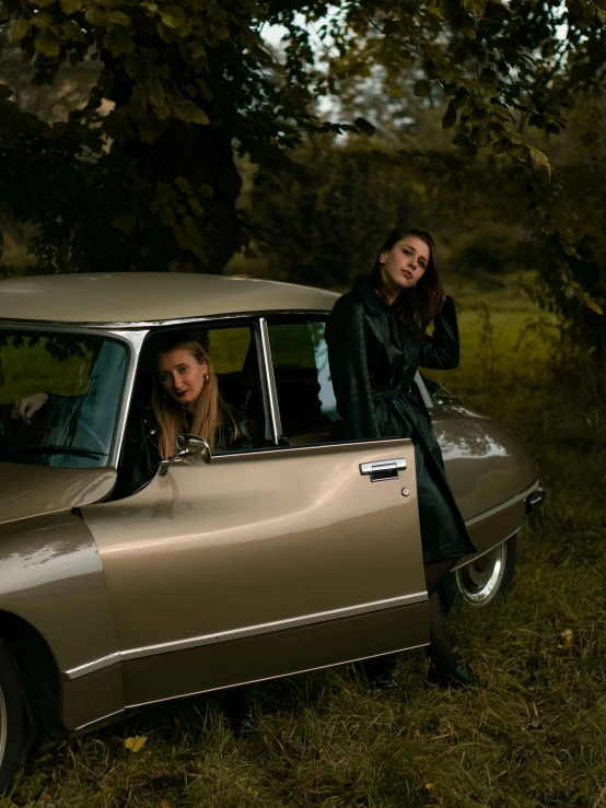 a couple of women standing next to a car, inspired by Nan Goldin, unsplash, magic realism, high quality photo, in the style dora maar, ad image