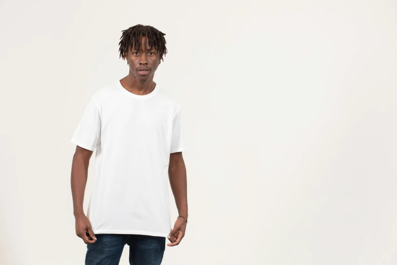 a young man standing with his hands in his pockets, unsplash, plain white tshirt, in front of white back drop, ignant, thumbnail