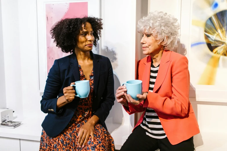 two women sitting next to each other holding coffee cups, art & language, seinfeld fancy tea party, press shot, bowater charlie and brom gerald, older woman