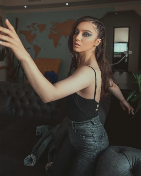 a beautiful young woman sitting on top of a couch, inspired by Elsa Bleda, trending on pexels, selfie photo, wearing a black bodysuit, standing in corner of room, t pose