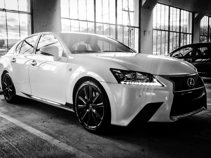 a black and white photo of a white car, luxigon, glossy white, in 2 0 1 5, intense color