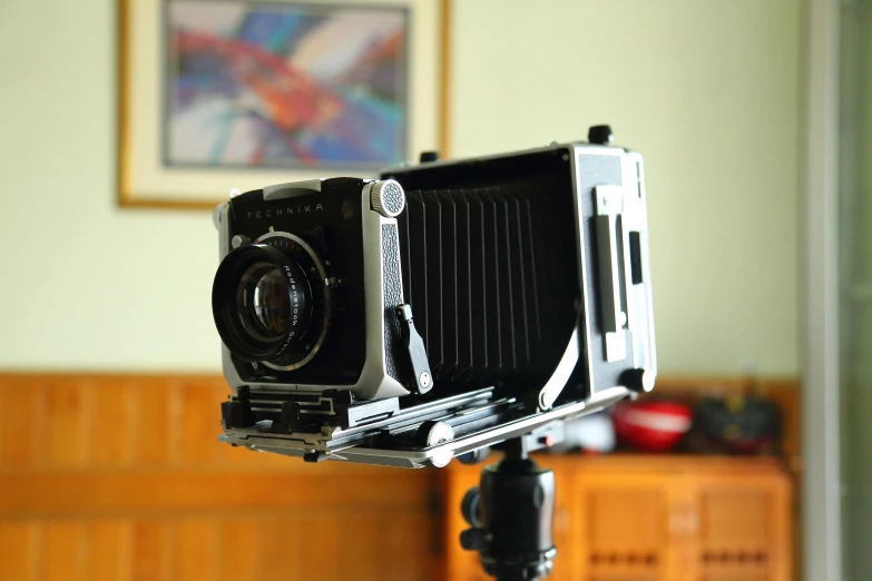 a close up of a camera on a tripod, by Yasushi Sugiyama, unsplash, photorealism, large format film camera, volumetric 8 k, rolleiflex tlr, indoor shot