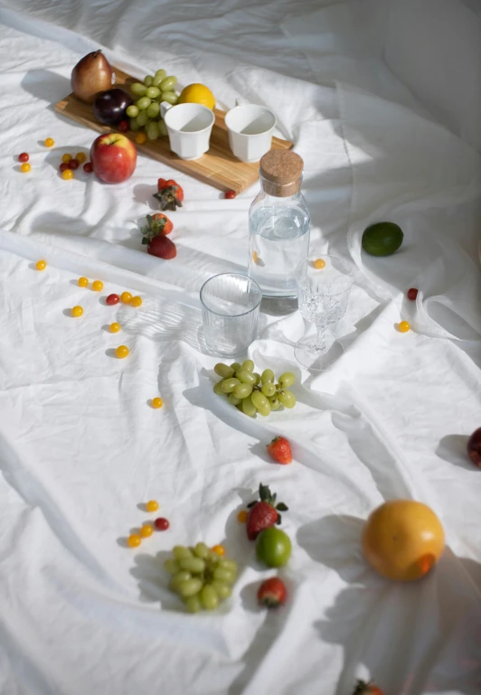 a table that has a bunch of fruit on it, unsplash contest winner, white sheets, hydration, play of light, 2 0 1 0 s