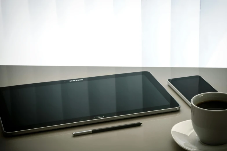 a tablet computer sitting on top of a table next to a cup of coffee, hyperdetailed samsung store, 15081959 21121991 01012000 4k, square, minimal shading