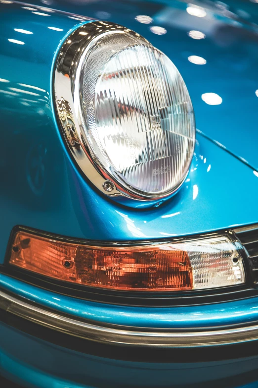 a close up of the front end of a blue car, pexels contest winner, 1974 porsche 911, side lighting, bright internal light, complementary rim lights