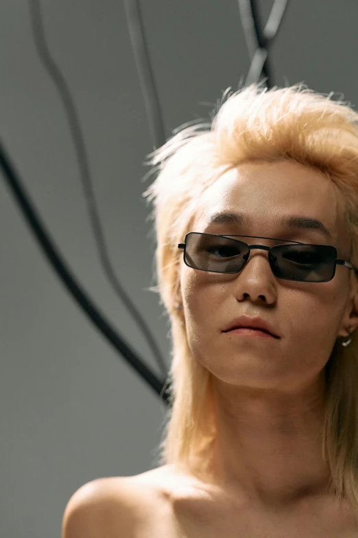 a woman with blonde hair and sunglasses holding a cell phone, an album cover, inspired by jeonseok lee, featured on reddit, photorealism, an epic non - binary model, asian man, hito steyerl, close up half body shot