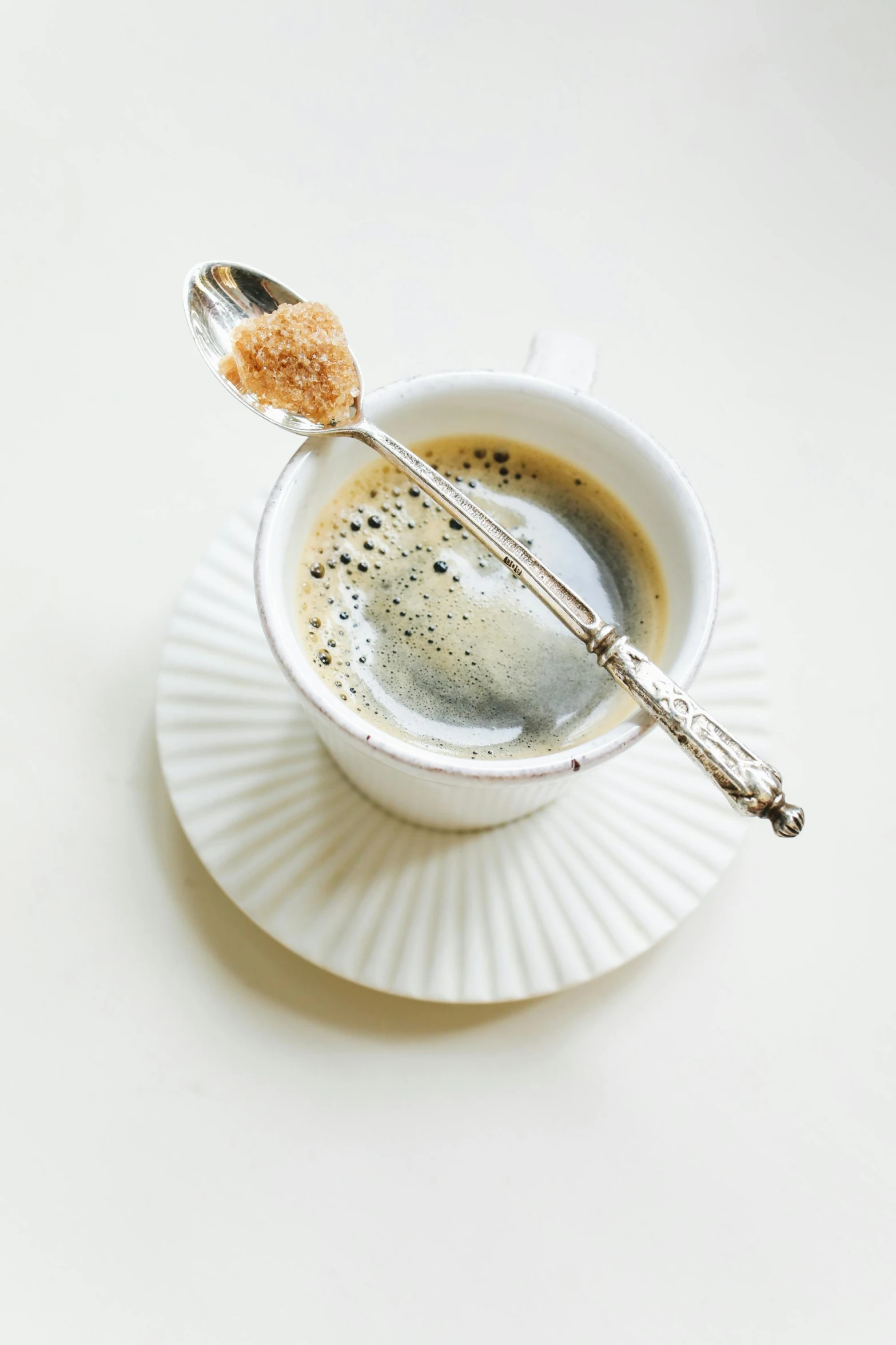 a cup of coffee with a spoon in it, renaissance, sugar sprinkled, thumbnail, grey, displayed