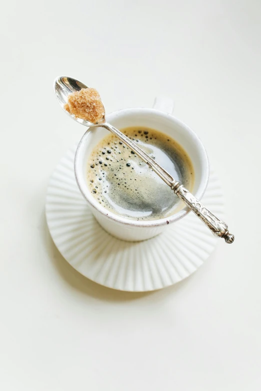 a cup of coffee with a spoon in it, renaissance, sugar sprinkled, thumbnail, grey, displayed