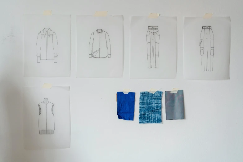 a person standing in front of a wall with drawings on it, a sketch, by Louisa Matthíasdóttir, behance, blue clothes, fabrics and textiles, in a row, knolling