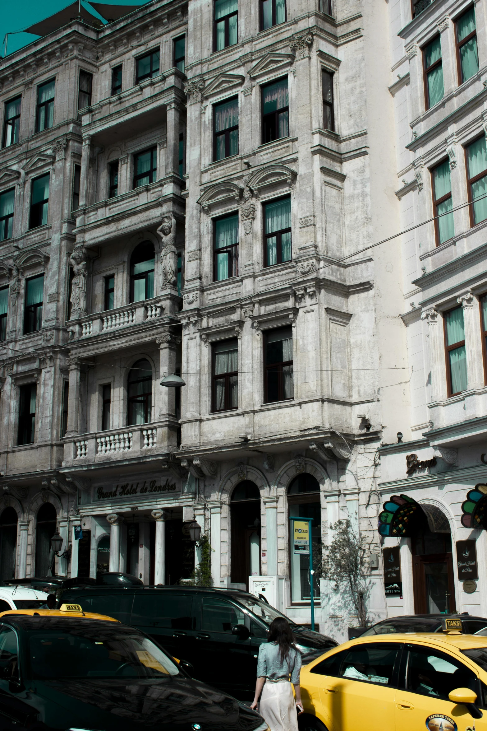 a couple of cars that are parked in front of a building, inspired by Mihály Munkácsy, art nouveau, hotel, kazakh empress, stone facade, street elevation