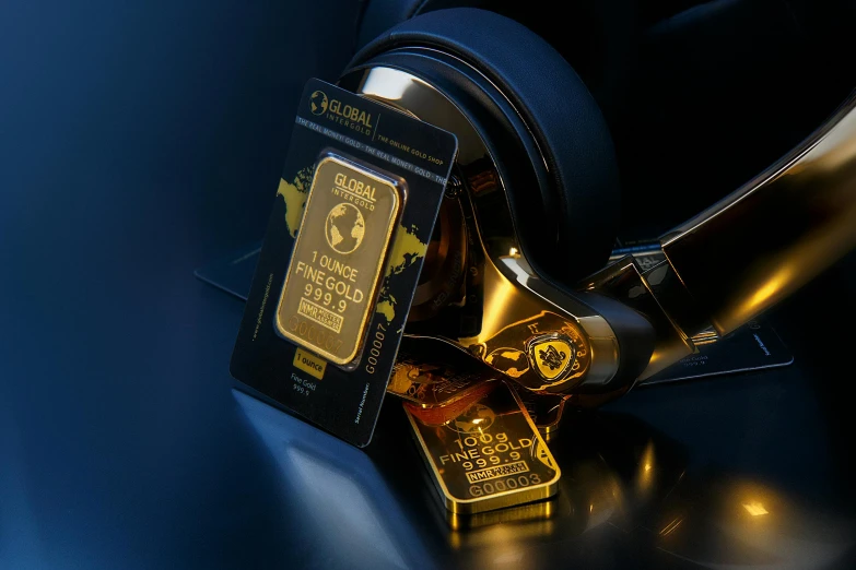 a pair of headphones sitting next to a gold bar, pexels contest winner, art nouveau, gold bars, global awarded, holographic artifacts, low quality photo