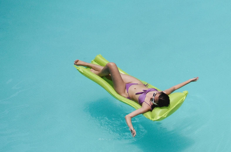 a woman laying on an inflatable raft in a pool, by Carey Morris, pexels contest winner, lime green, panels, weightless, 15081959 21121991 01012000 4k