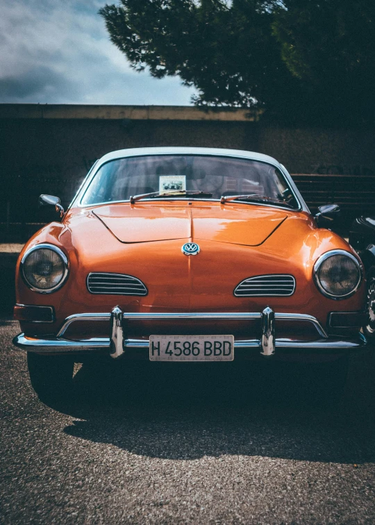 an orange car parked in a parking lot, by Adam Marczyński, pexels contest winner, renaissance, highly detailed hyper real retro, square, sport car, brown