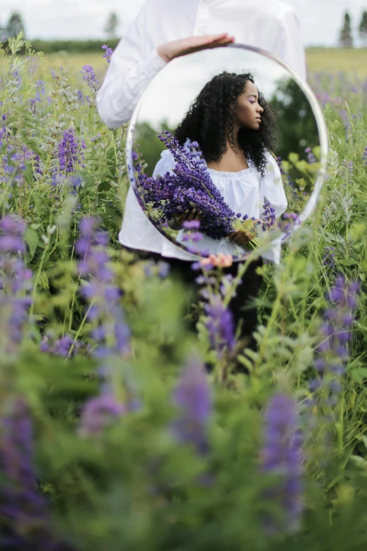 a woman standing in a field of purple flowers, inside mirror, sza, herbs and flowers, with a mirror