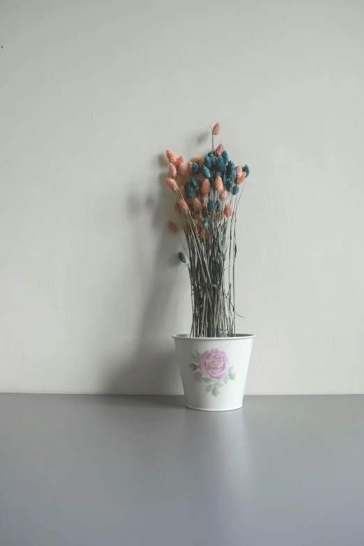 a flower pot sitting on a table next to a wall, a colorized photo, inspired by Frieke Janssens, unsplash, hyperrealism, flower buds, grey porcelain sculpture, with soft pink colors, willow plant