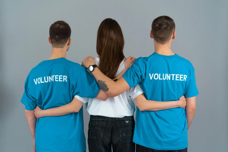 a group of people standing next to each other, pexels contest winner, hurufiyya, wearing a t-shirt, healthcare worker, back view also, three colors