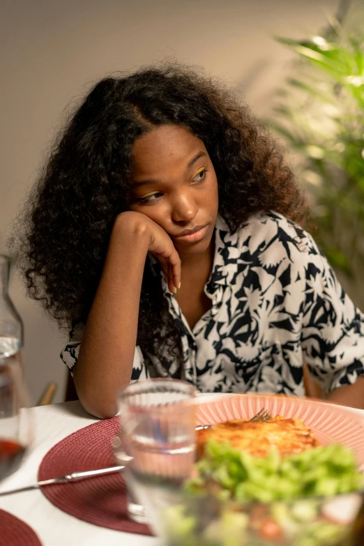 a woman sitting at a table with a plate of food, heartbroken, black teenage girl, promo image, family dinner