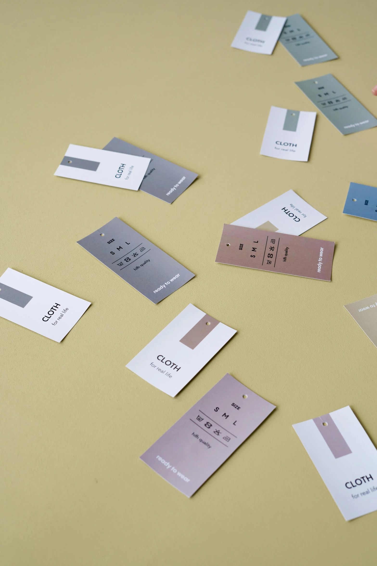 a bunch of business cards sitting on top of a table, color field, product label, grey, cuts, labelled