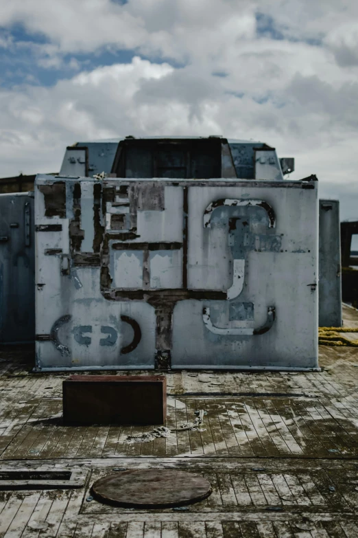 a large piece of metal sitting on top of a roof, unsplash, graffiti, military carrier rig, high resolution photo, ignant, bunkers