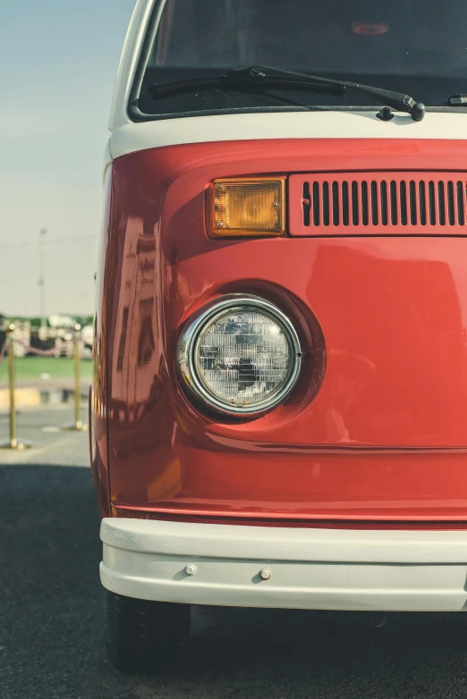 a red and white van parked in a parking lot, pexels contest winner, headlight washer, 1 9 7 0 s car window closeup, square nose, public bus