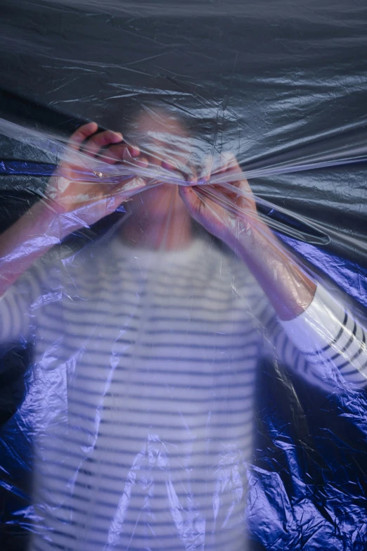 a blurry image of a woman covering her face with plastic, plasticien, ripping the fabric of spacetime, teenage boy, promo image, rectangle