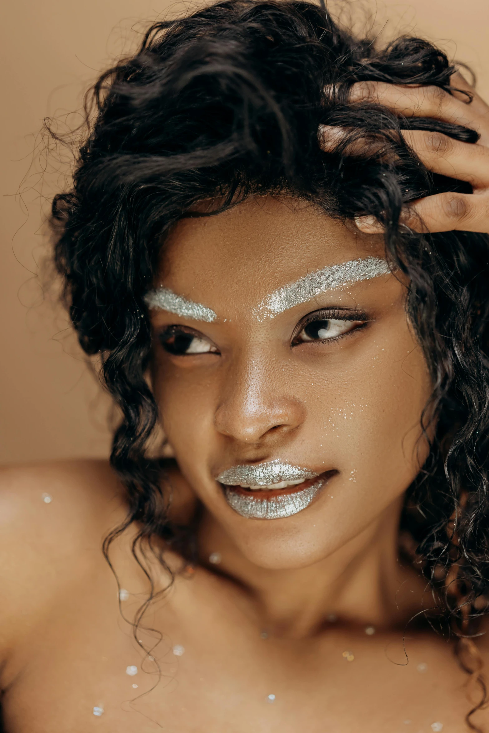 a close up of a woman with glitter on her face, inspired by Man Ray, trending on pexels, afrofuturism, silver，ivory, portrait of sherlyn chopra, wavy hair spread out, model posing