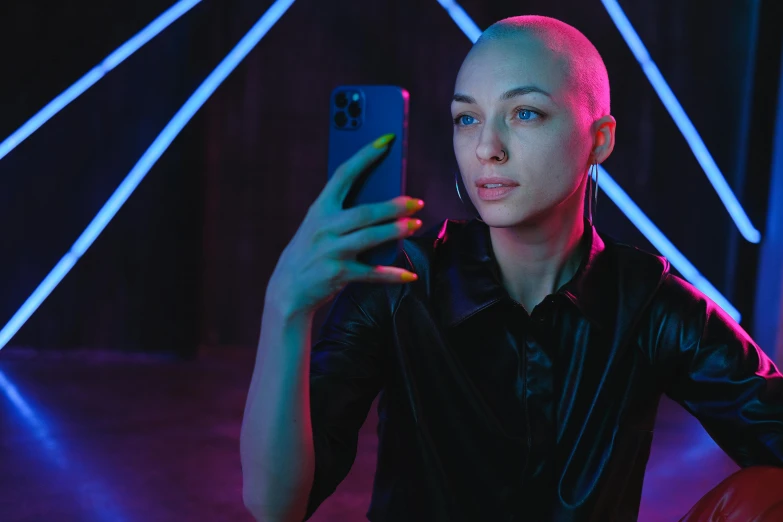 a close up of a person holding a cell phone, by Julia Pishtar, buzz cut hair, bisexual lighting, anton fadeev 8 k, instagram picture