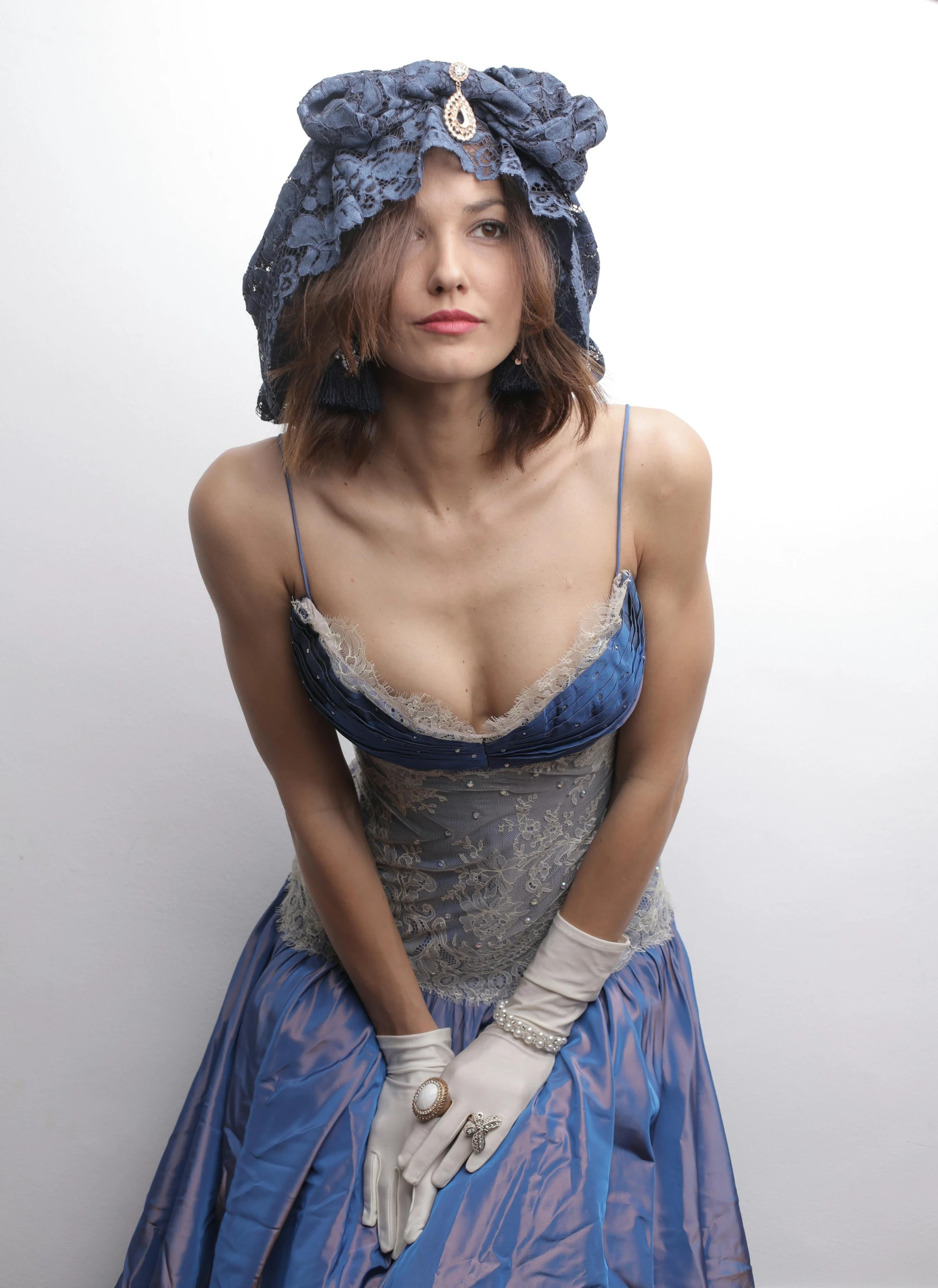 a woman in a blue dress posing for a picture, an album cover, inspired by Mikhail Vrubel, flickr, suit vest and top hat and gloves, gemma chan beautiful girl, thin aged 2 5, 5 0 0 px models