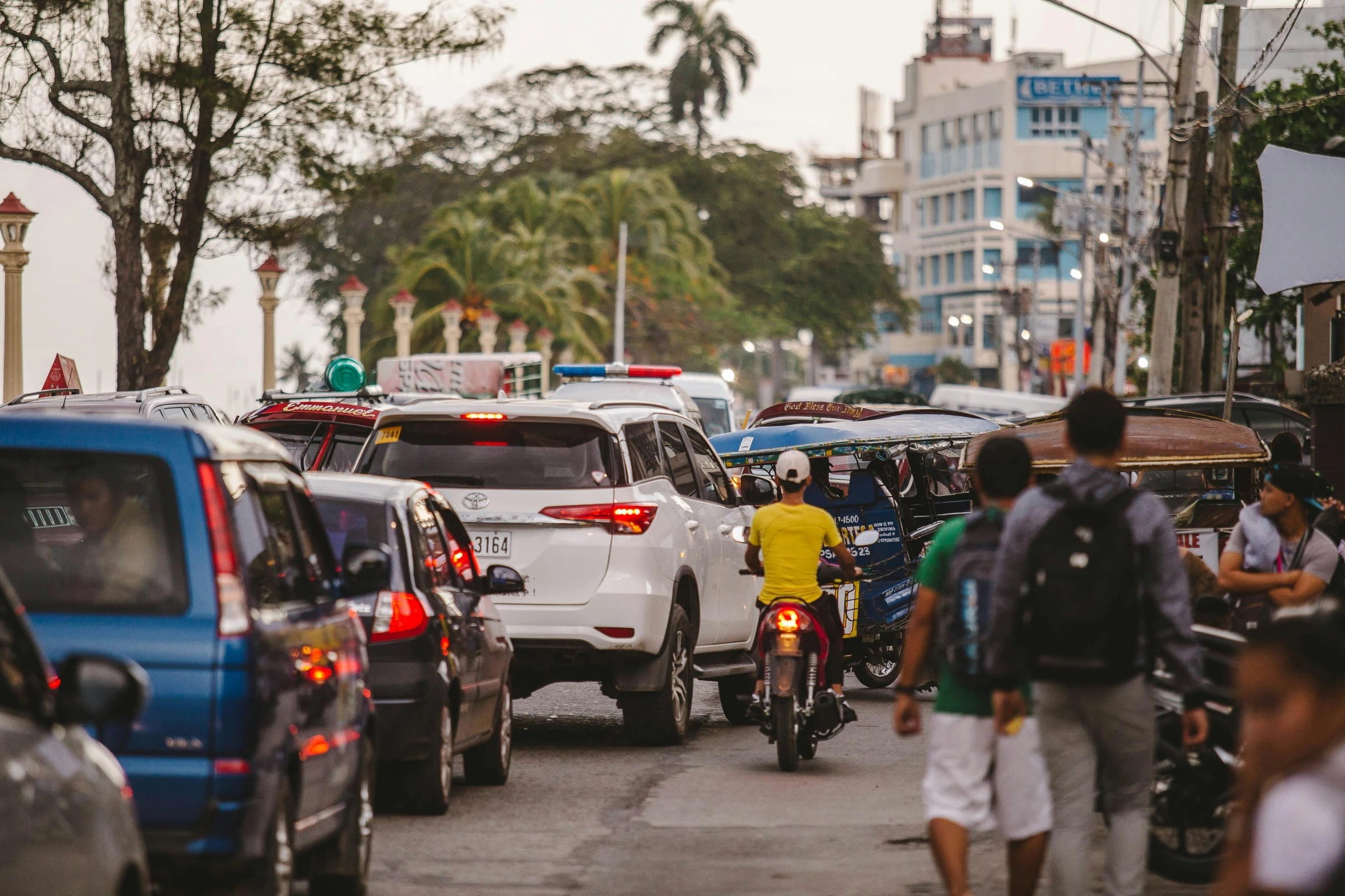 a busy city street filled with lots of traffic, pexels contest winner, philippines, avatar image, tropical coastal city, square