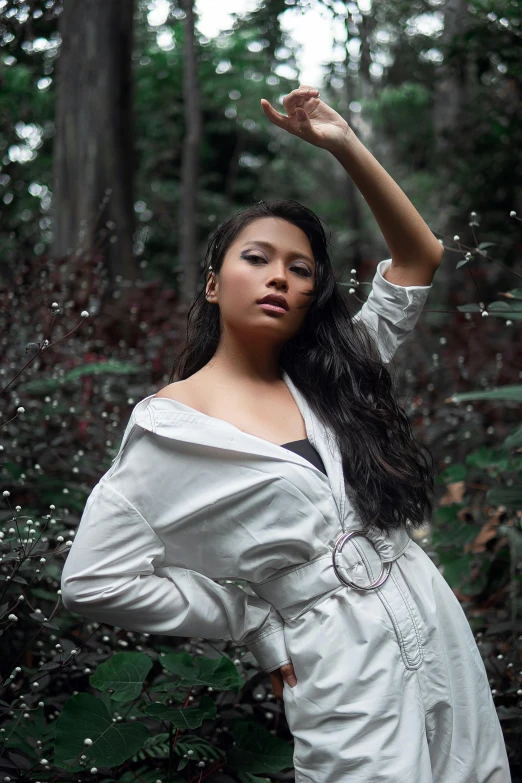 a woman standing in the middle of a forest, an album cover, inspired by Natasha Tan, unsplash, sumatraism, wearing white shirt, glamour pose, just after rain, concert