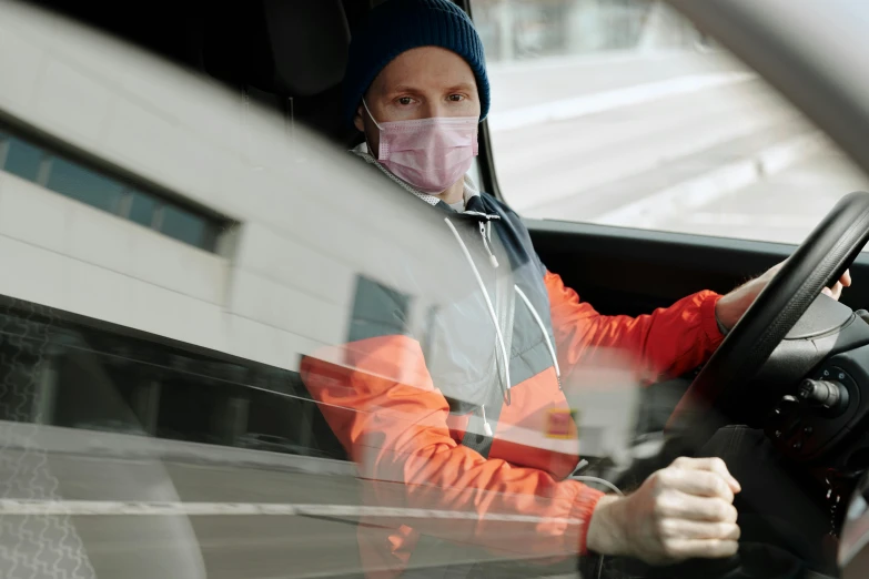 a man wearing a face mask behind the wheel of a car, a picture, jenni pasanen, extra high resolution, sweat and labour, avatar image