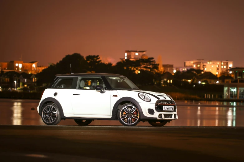 a white mini cooper parked on the side of the road, a cartoon, by Julia Pishtar, unsplash, shot at night with studio lights, square, gtr xu1, shot on sony a 7