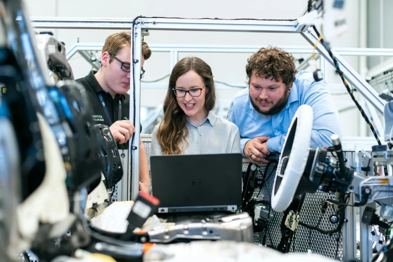 a couple of people that are looking at a laptop, mechanical engineering, lachlan bailey, avatar image, high-quality photo