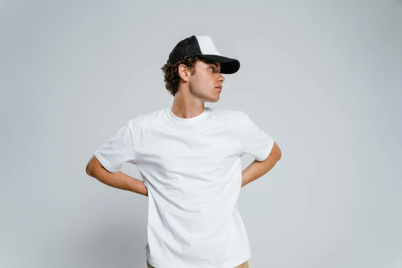 a young man wearing a white t - shirt and khaki pants, trending on pexels, baseball cap, gradient black to silver, default pose neutral expression, minimal clothing