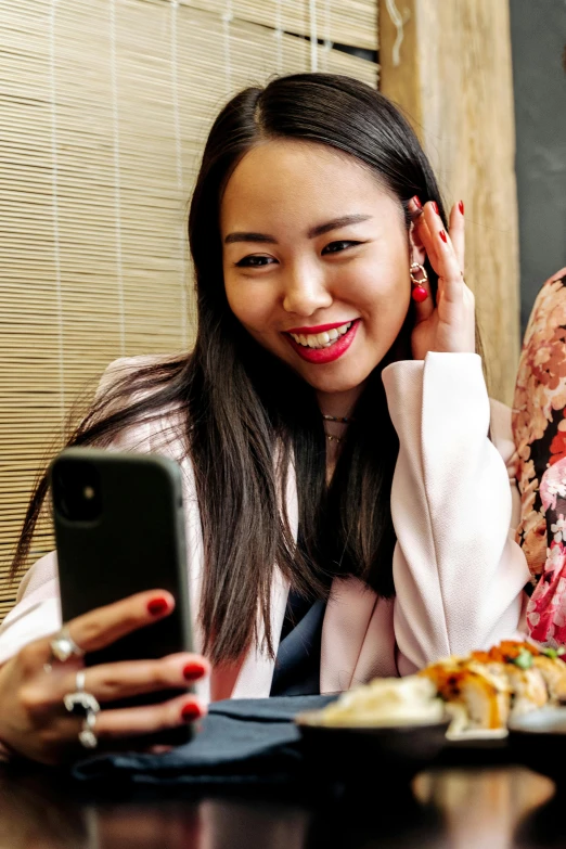 a woman sitting at a table with a plate of food, taking a selfie, asian features, gen z, award-winning style