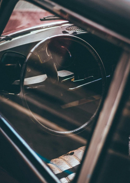 a close up of a steering wheel in a car, a picture, inspired by Elsa Bleda, unsplash, hypermodernism, profile image, looking into a mirror, album cover, all enclosed in a circle