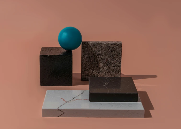 a blue ball sitting on top of a marble block, an abstract sculpture, inspired by Harvey Quaytman, suprematism, black and terracotta, mauve and cyan, various sizes, crystalline
