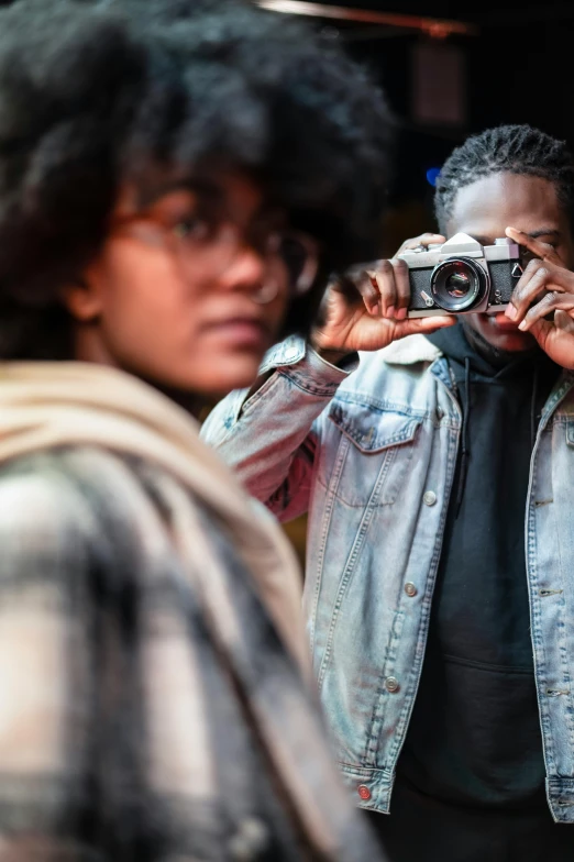 a man taking a picture of a woman with a camera, a picture, inspired by Gordon Parks, trending on unsplash, black teenage boy, ultrawide lens”, sharp focus », looking into a mirror