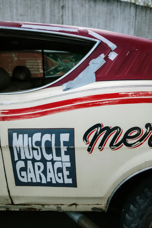 a red and white muscle garage car parked next to a building, by Dave Melvin, merciless, old signs, up close, profile image